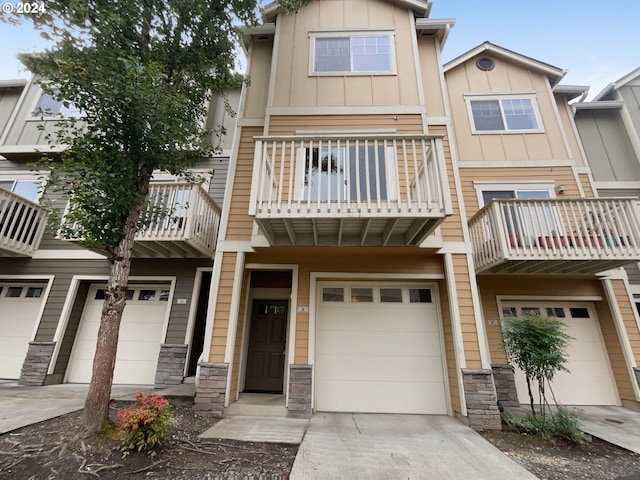 townhome / multi-family property with a garage and a balcony