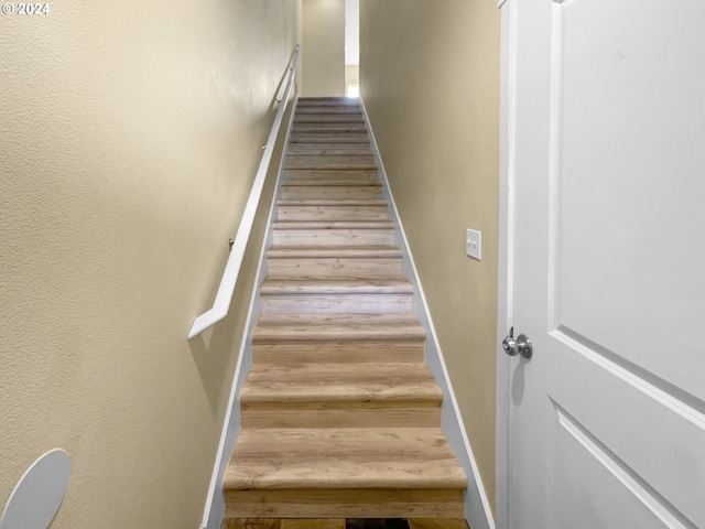 staircase featuring hardwood / wood-style flooring