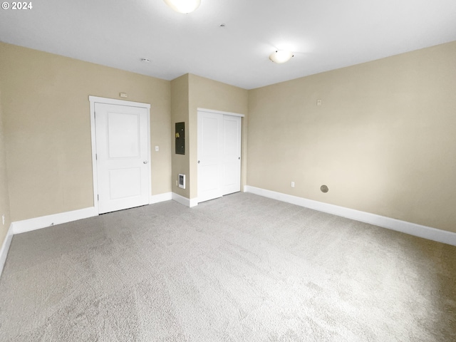 carpeted empty room featuring electric panel