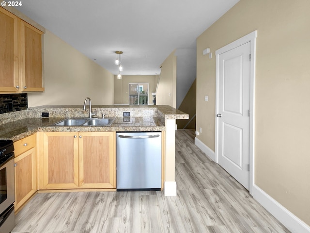 kitchen featuring light wood-type flooring, kitchen peninsula, stainless steel dishwasher, and sink