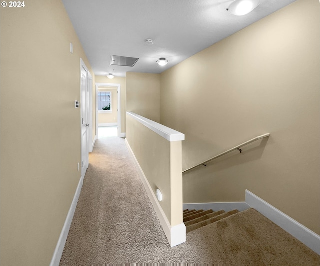 hall with light colored carpet