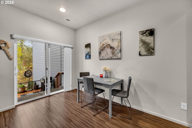 dining room with visible vents, baseboards, and wood finished floors