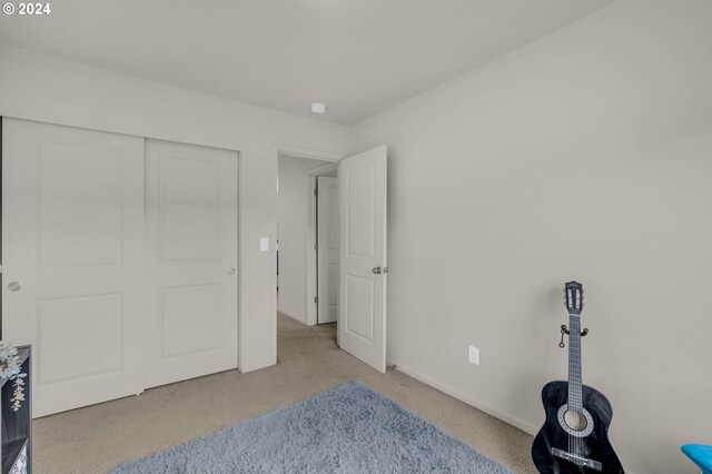 carpeted bedroom with a closet