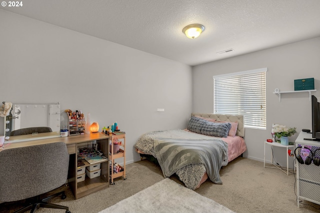 carpeted bedroom with a textured ceiling