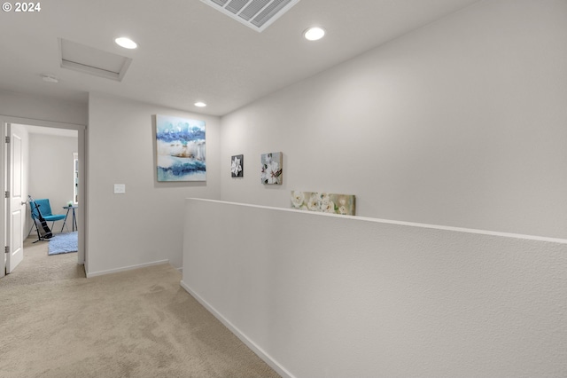 hallway with recessed lighting, visible vents, attic access, light carpet, and baseboards