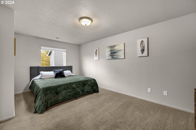 carpeted bedroom with a textured ceiling