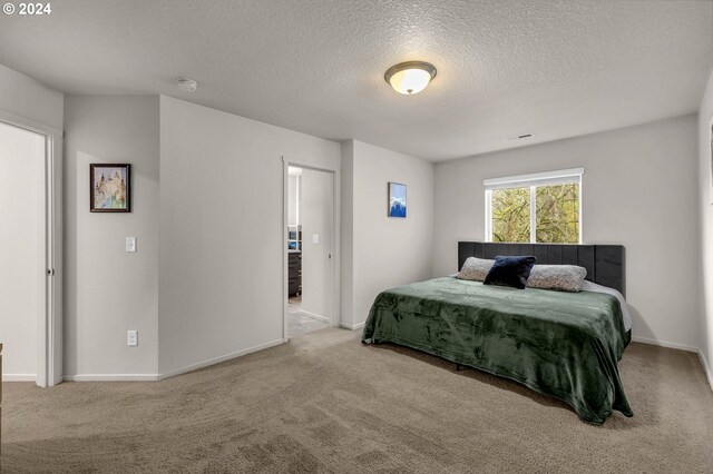 carpeted bedroom with a textured ceiling