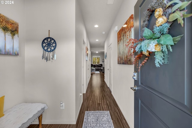 hall featuring dark wood-style floors, recessed lighting, and baseboards