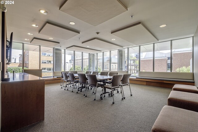 dining space featuring carpet flooring and expansive windows