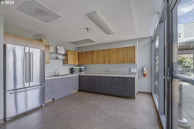 kitchen with sink, gray cabinets, and fridge