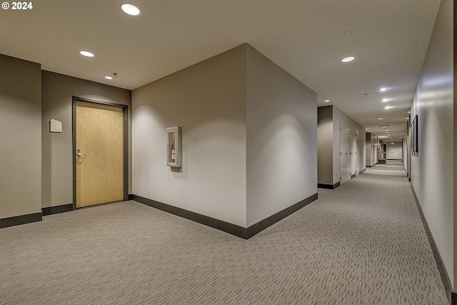 corridor featuring light colored carpet