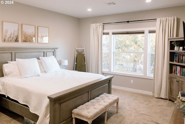 carpeted bedroom featuring multiple windows