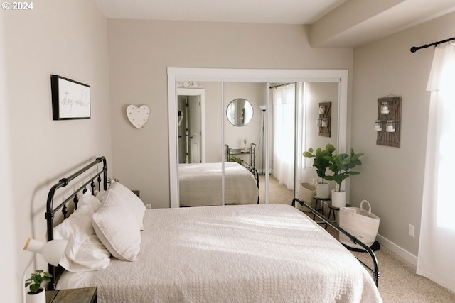 bedroom featuring a closet, carpet, and multiple windows