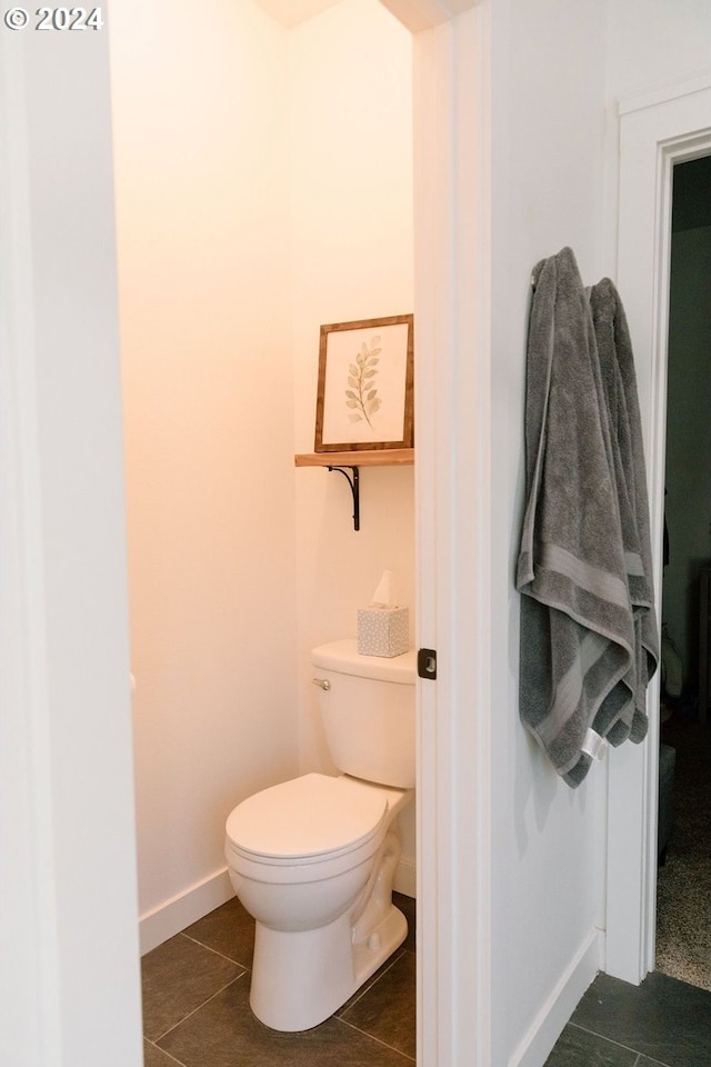 bathroom with toilet and tile patterned floors