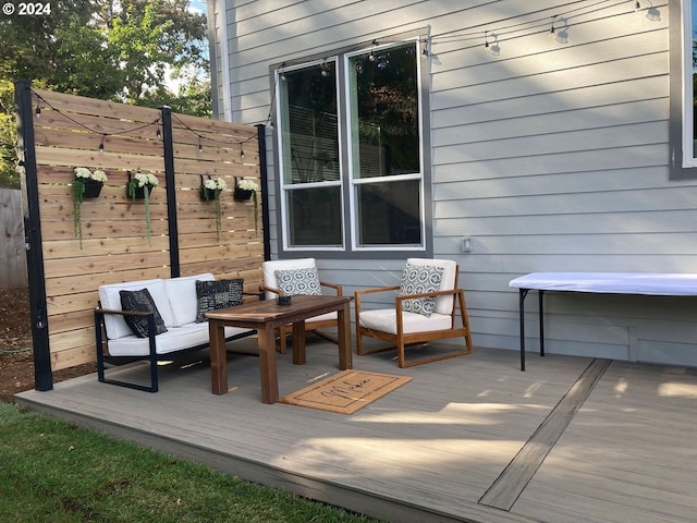 wooden deck with an outdoor living space