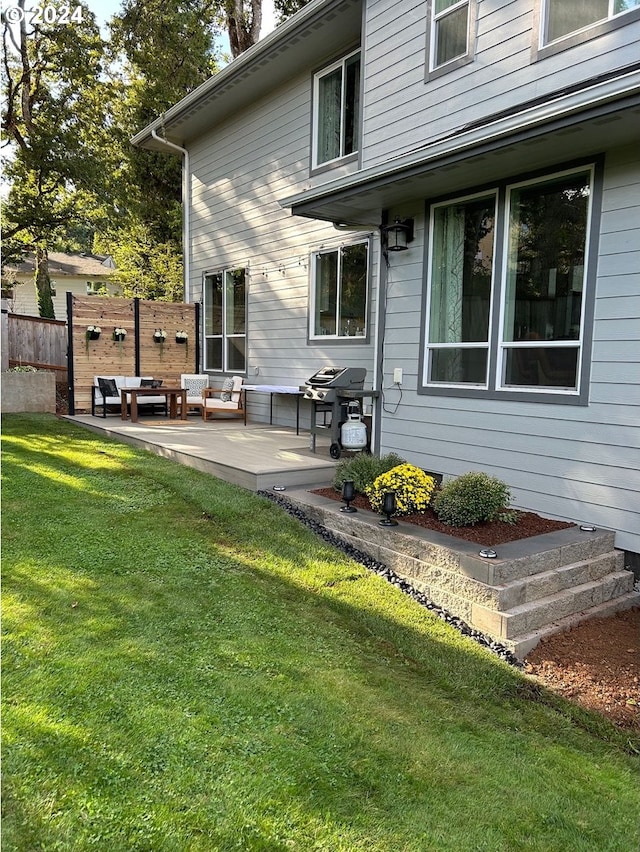 rear view of property with a patio area, a lawn, and an outdoor hangout area