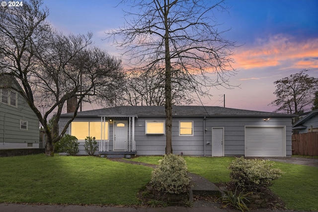 view of front facade featuring a yard and a garage