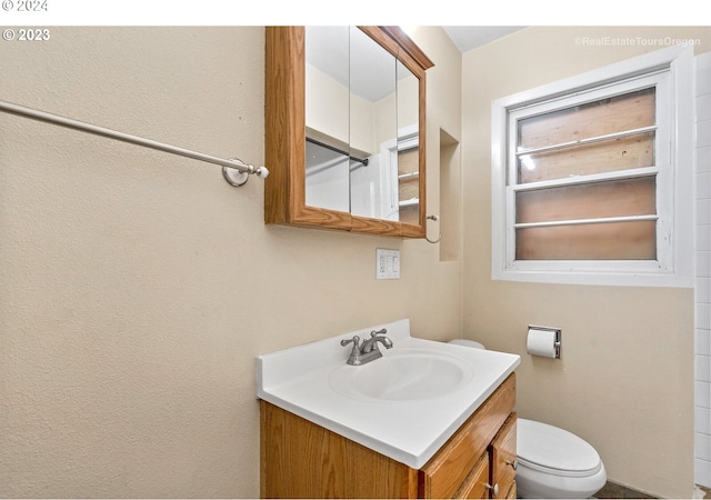 bathroom featuring vanity and toilet