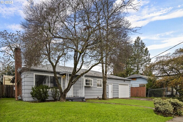 view of front of house featuring a garage and a front yard