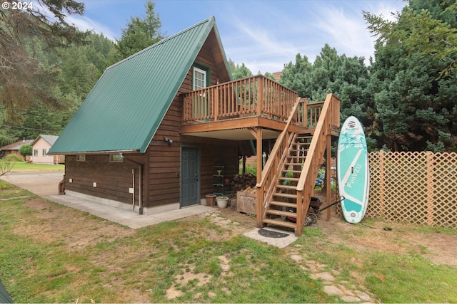 view of jungle gym featuring stairs, a yard, and a wooden deck