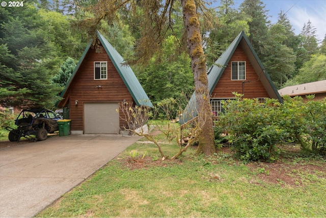 view of front of house featuring an outbuilding, concrete driveway, a detached garage, and metal roof