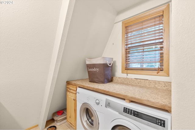 clothes washing area with light tile patterned flooring and washer and dryer