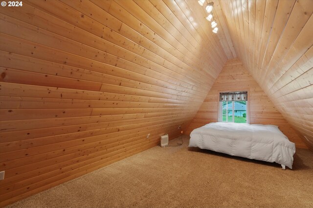 bedroom featuring lofted ceiling, wood ceiling, wooden walls, and carpet flooring