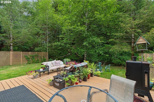 deck with a yard and outdoor lounge area