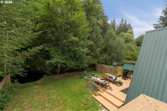 view of yard featuring a wooden deck and outdoor lounge area