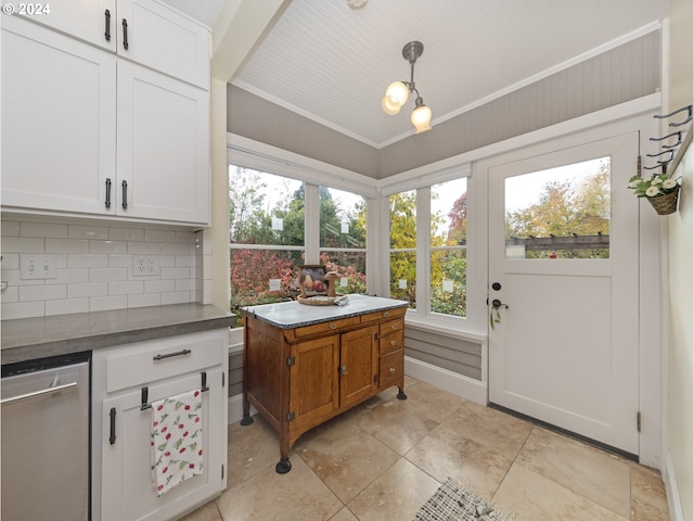 interior space with decorative light fixtures, crown molding, white cabinetry, and backsplash