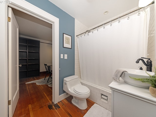 bathroom featuring vanity, wood-type flooring, and toilet