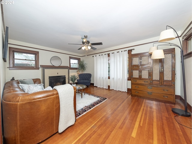 living room featuring ceiling fan, plenty of natural light, and hardwood / wood-style flooring