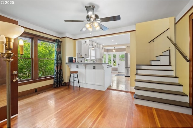 1718 23rd Ave, Forest Grove, OR 97116 - kitchen with a ceiling fan, freestanding refrigerator, white cabinetry, and a peninsula