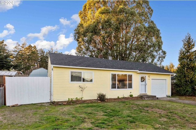 view of front facade with a garage and a front lawn