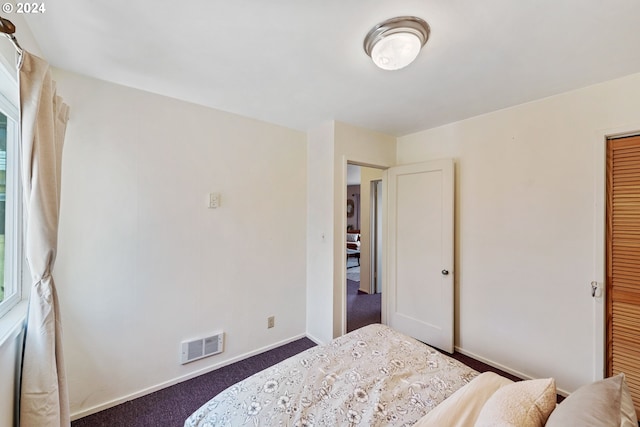 carpeted bedroom featuring a closet