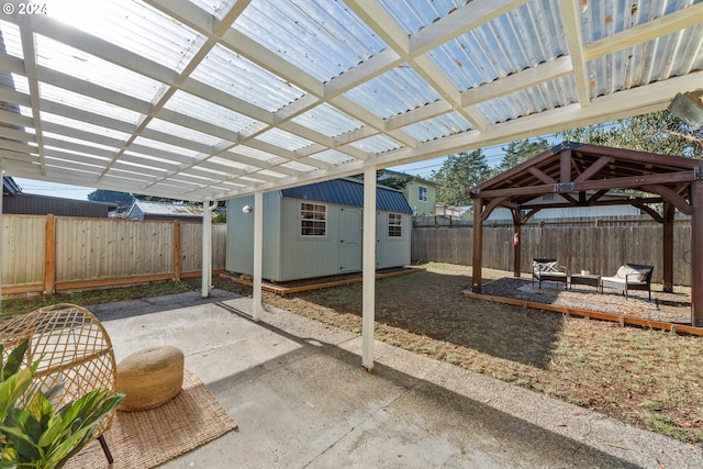 view of patio with a gazebo and a shed