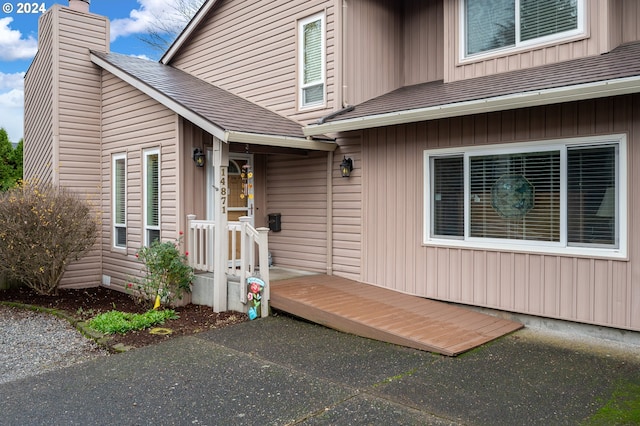 view of exterior entry with a wooden deck