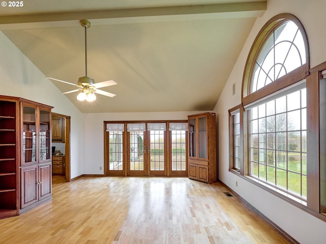 unfurnished living room with high vaulted ceiling, ceiling fan, light hardwood / wood-style floors, and beamed ceiling