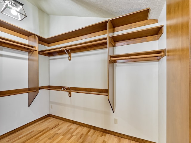 walk in closet featuring light hardwood / wood-style flooring