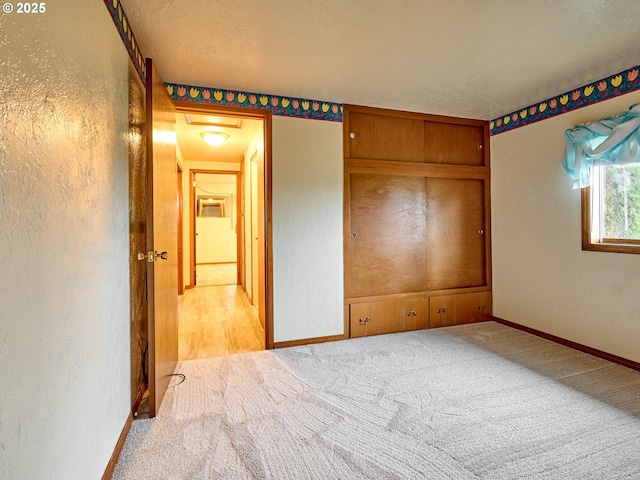 unfurnished bedroom with a textured ceiling and carpet