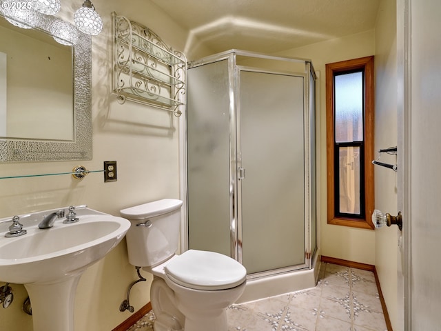 bathroom with toilet, tile patterned flooring, an enclosed shower, and sink