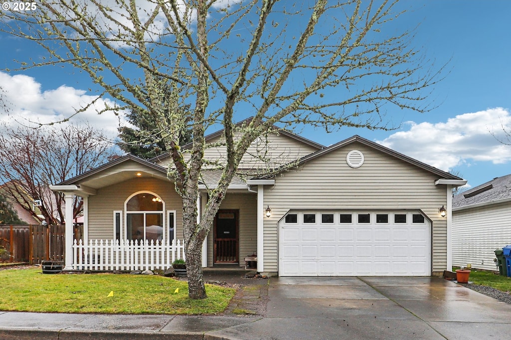 view of front of property with a front yard and a garage