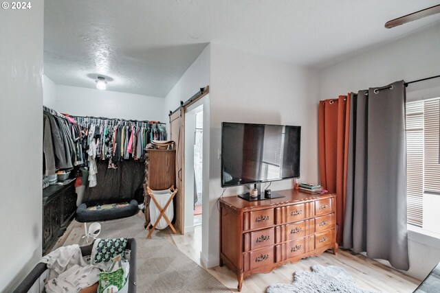 interior space with a barn door and light hardwood / wood-style floors