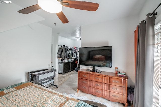 bedroom with a ceiling fan and light wood-style floors