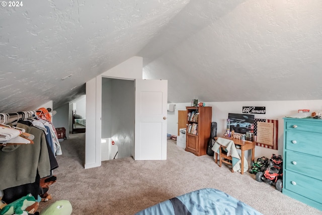 bedroom featuring light carpet, a textured ceiling, and lofted ceiling