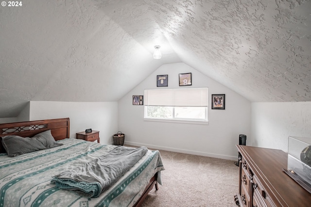 bedroom featuring lofted ceiling, carpet, baseboards, and a textured ceiling