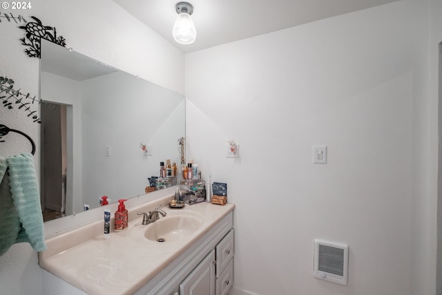 bathroom featuring heating unit and vanity