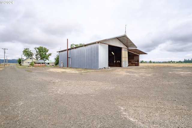 view of outbuilding featuring dirt driveway