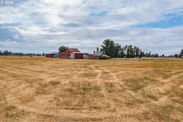 view of yard featuring a rural view and a barn