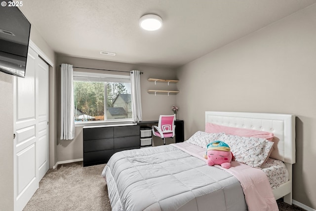 carpeted bedroom featuring a closet